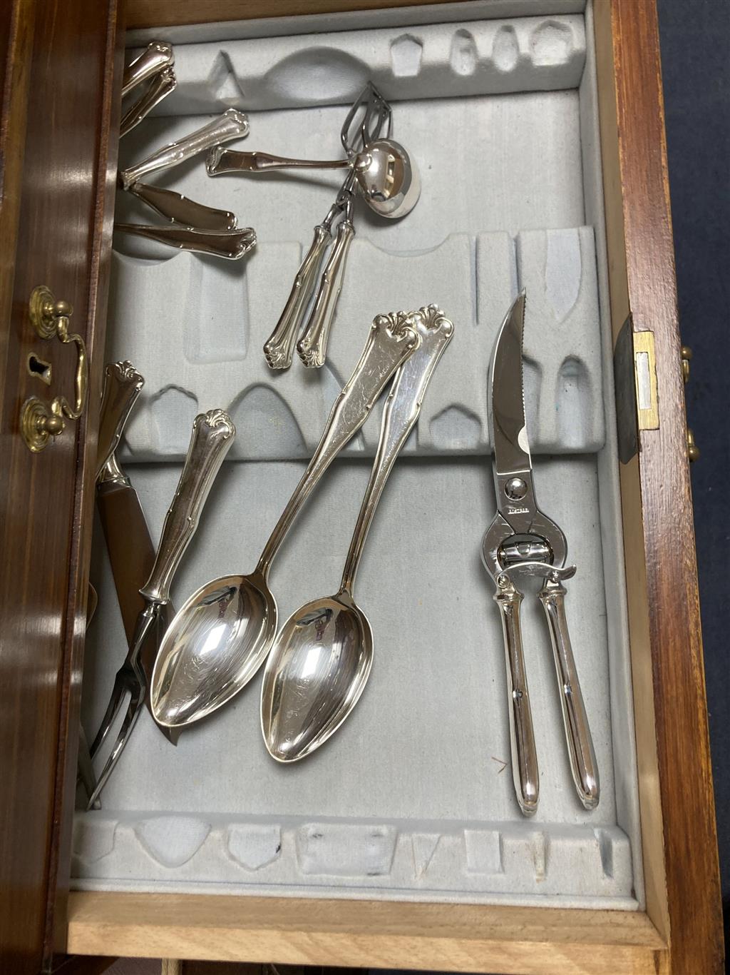 A canteen of plated cutlery contained a fitted case, settings for twelve